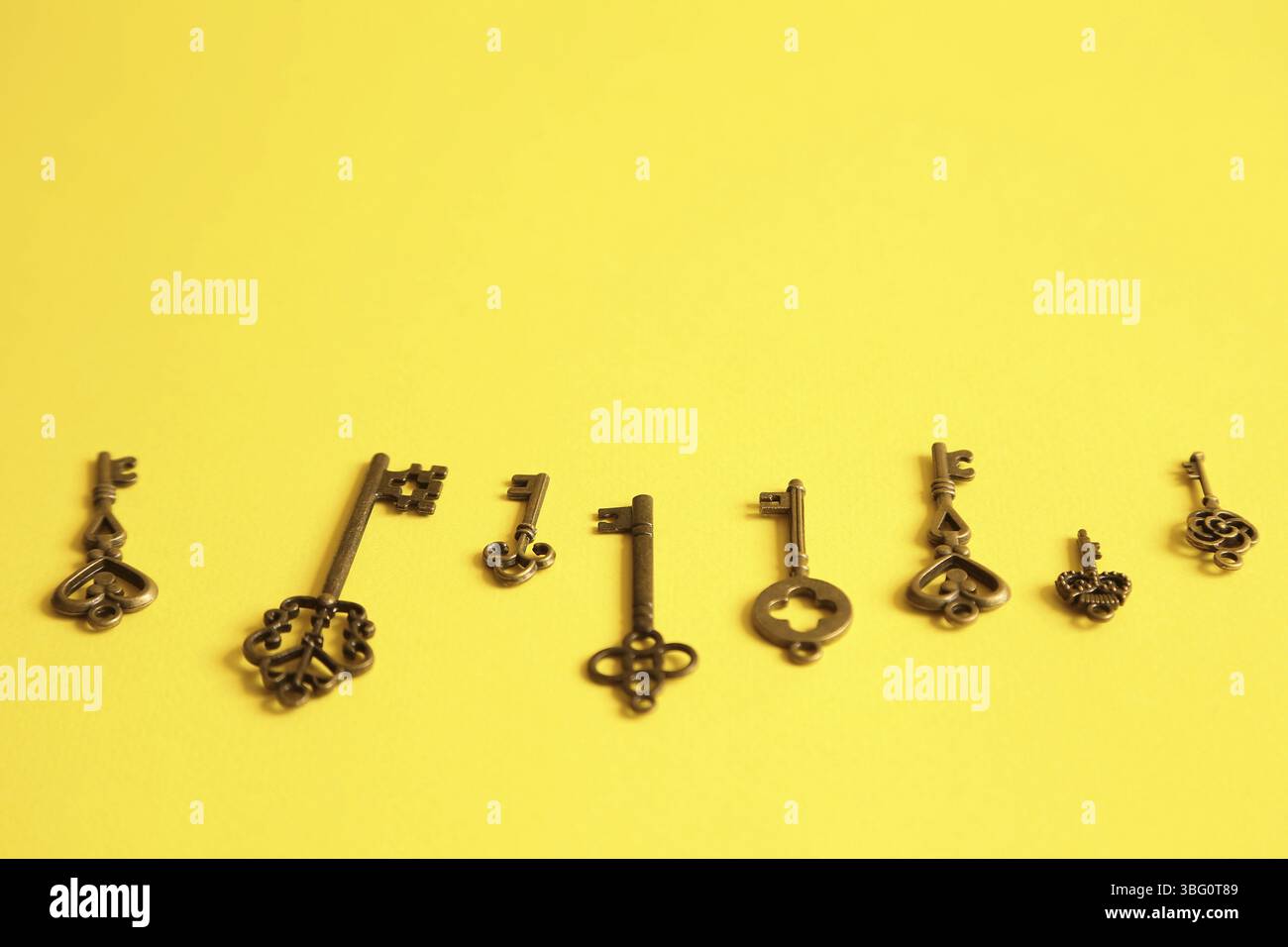 Different keys on yellow background. Choice and right solution concept Stock Photo