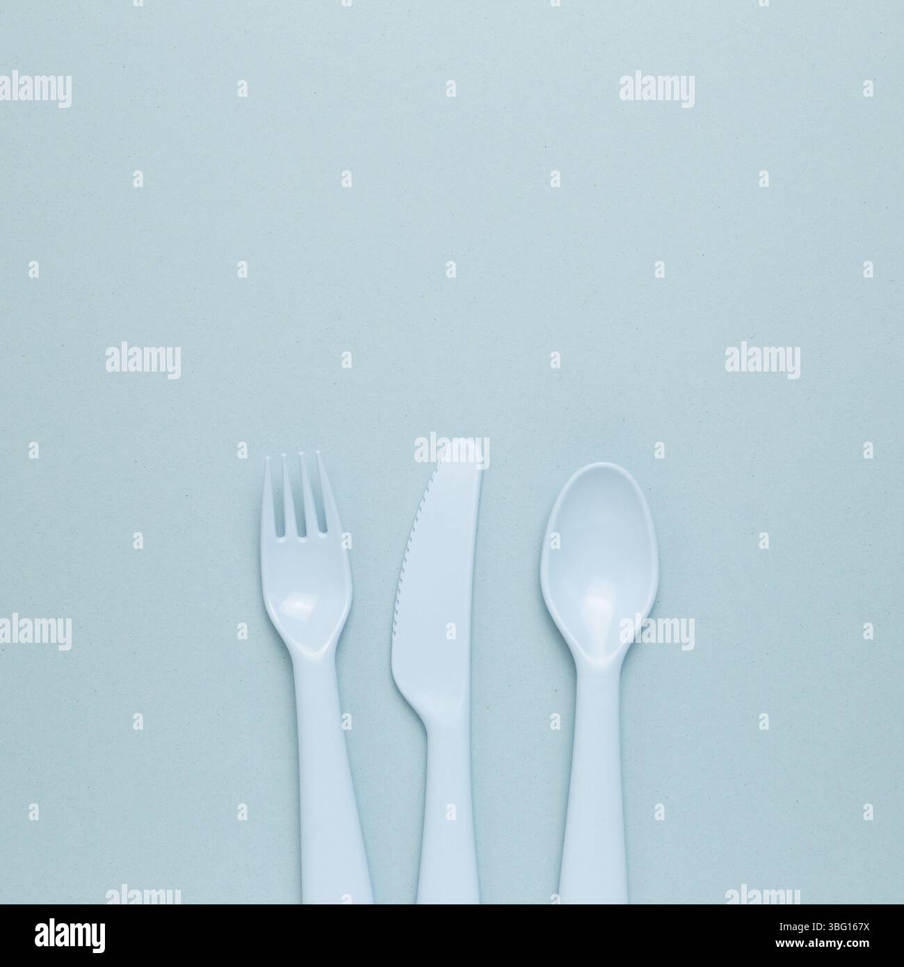 Fork knife spoon on sky blue background. flat lay, top view, copy space Stock Photo