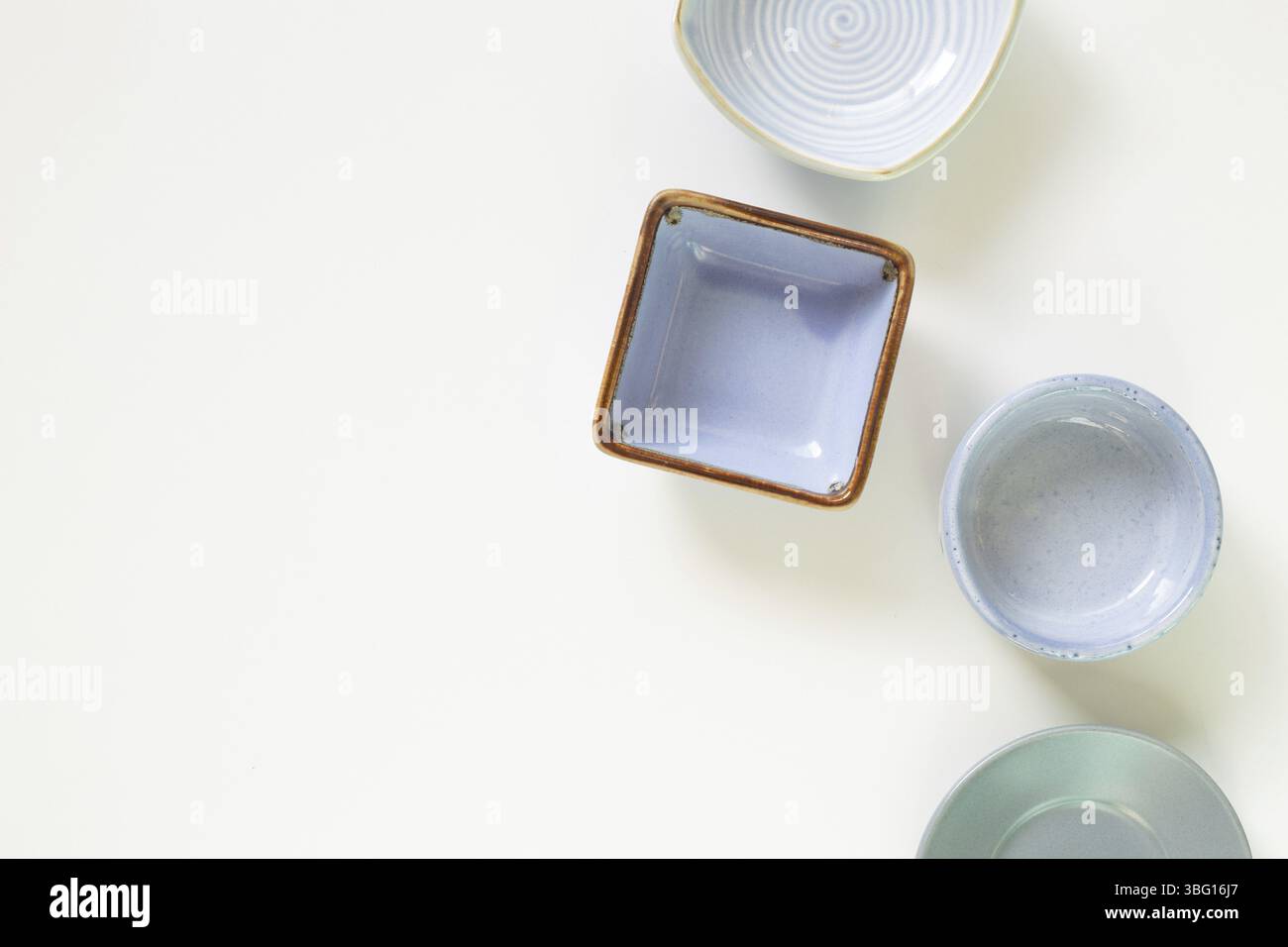 Colorful empty plates on white background. flat lay, top view, copy space Stock Photo