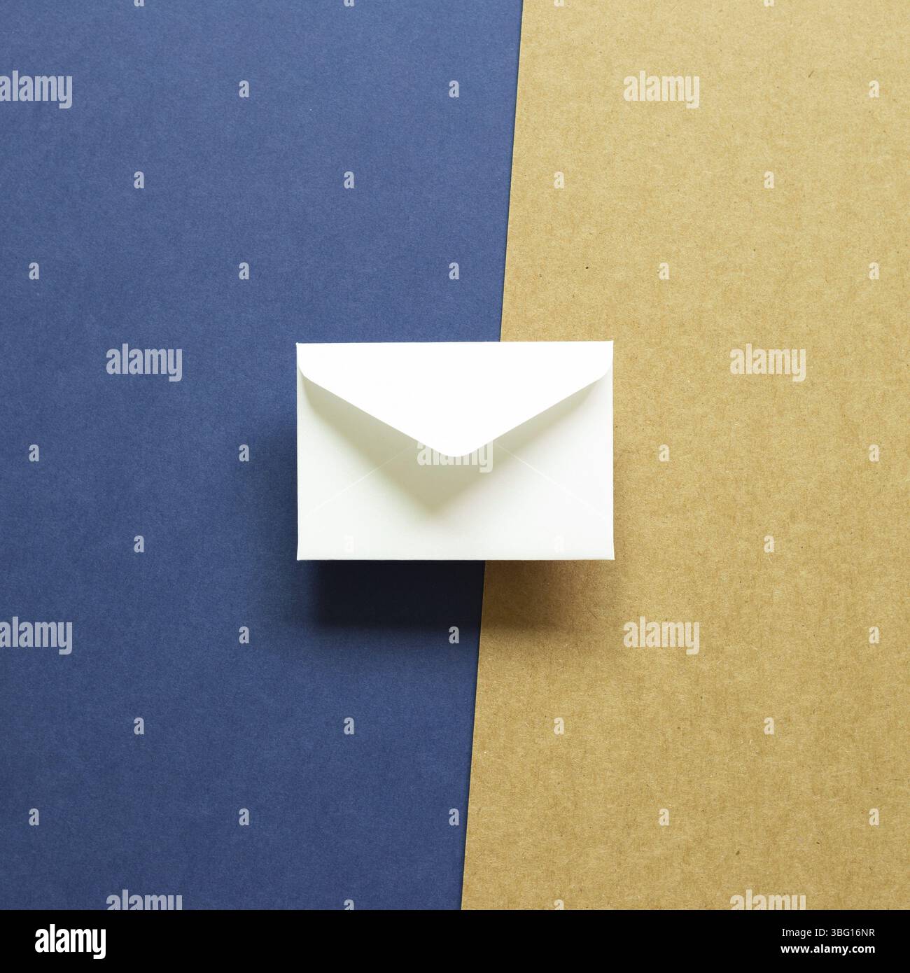 White envelope on blue and brown background. top view, copy space Stock Photo
