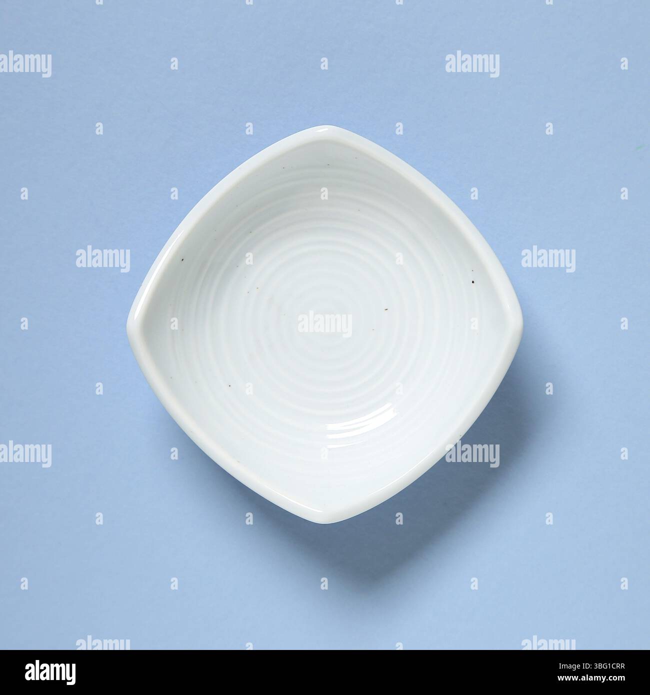 Light blue dish isolated on blue background Stock Photo
