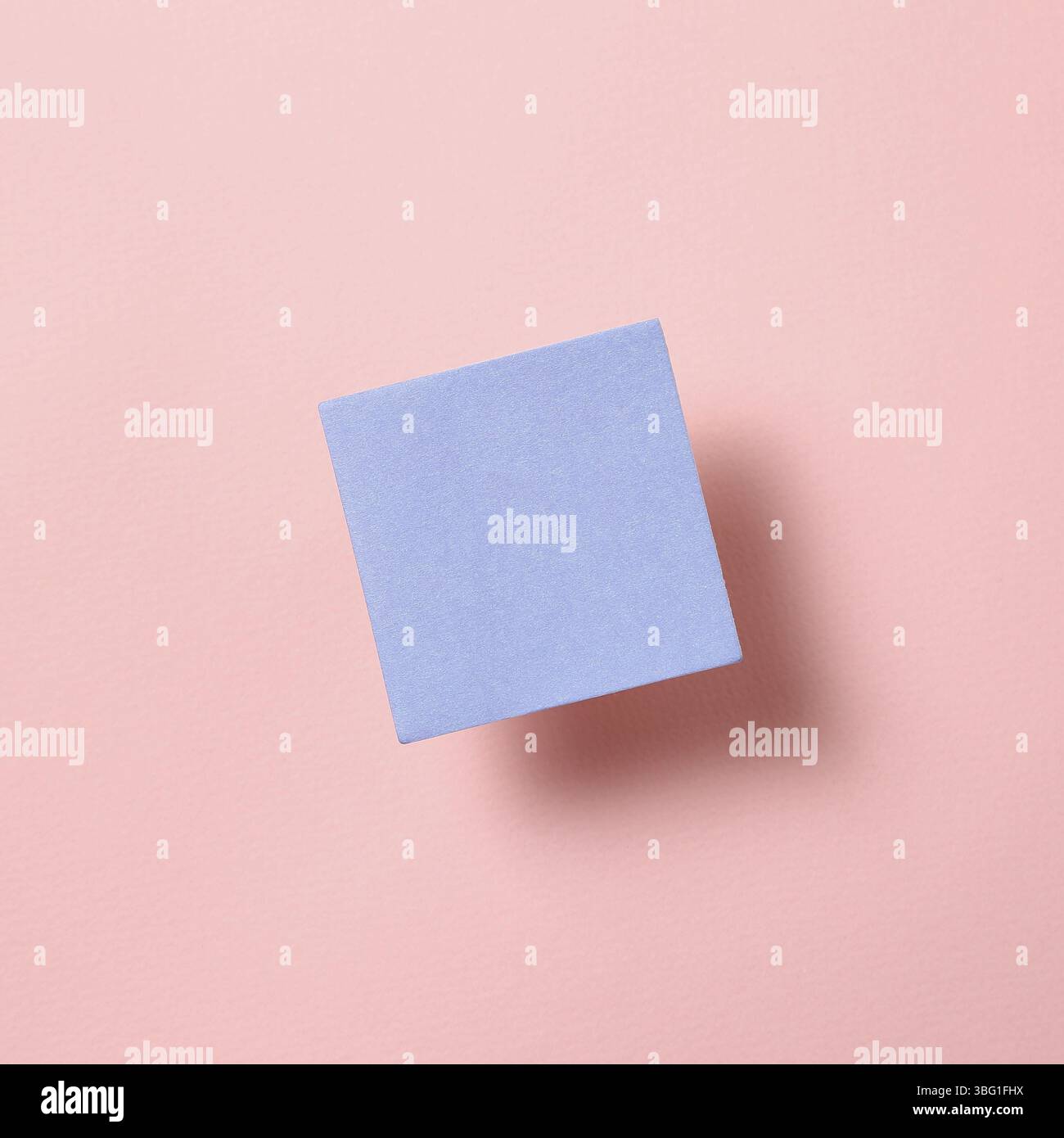 Blue memo pad, sticky note on pink background Stock Photo