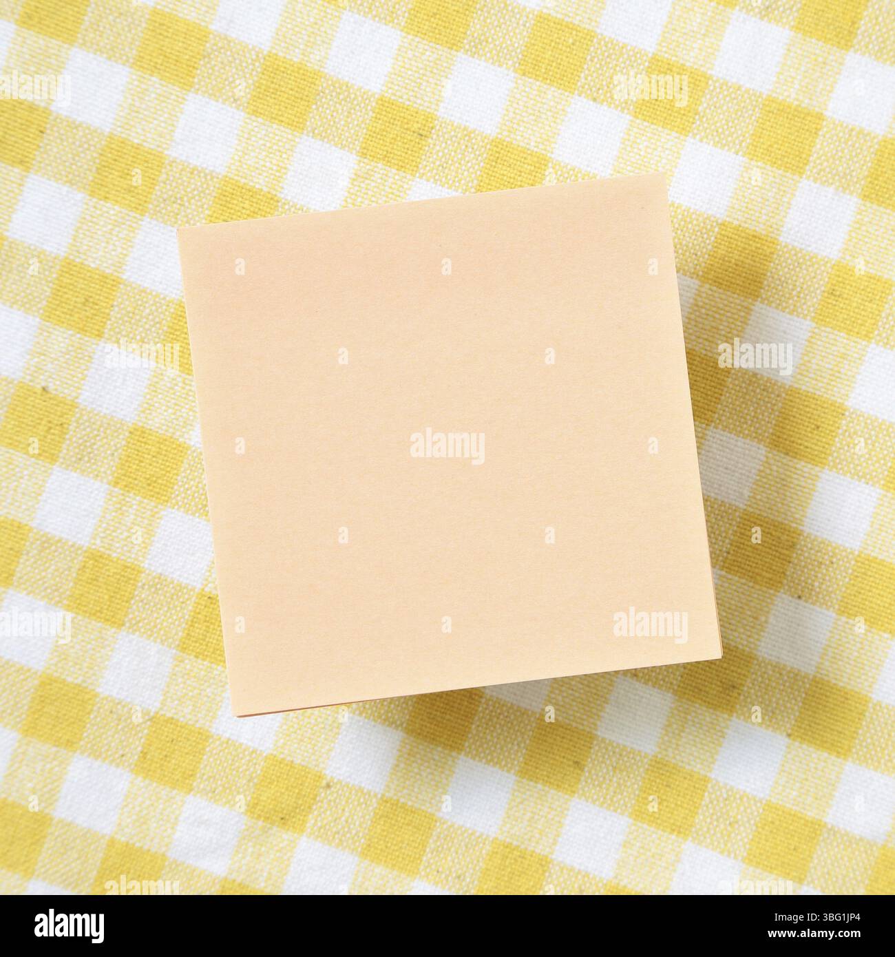 Reminder sticky notes on yellow check pattern fabric background Stock Photo