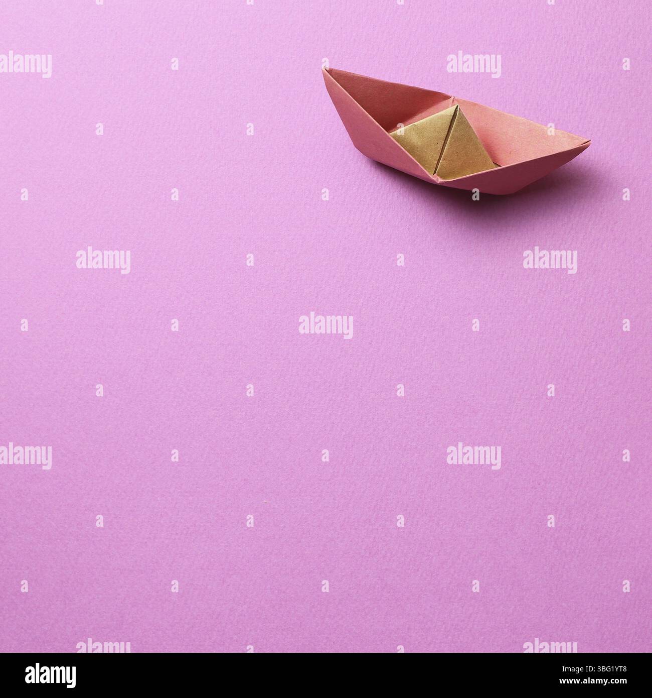 Paper ship on pink background Stock Photo