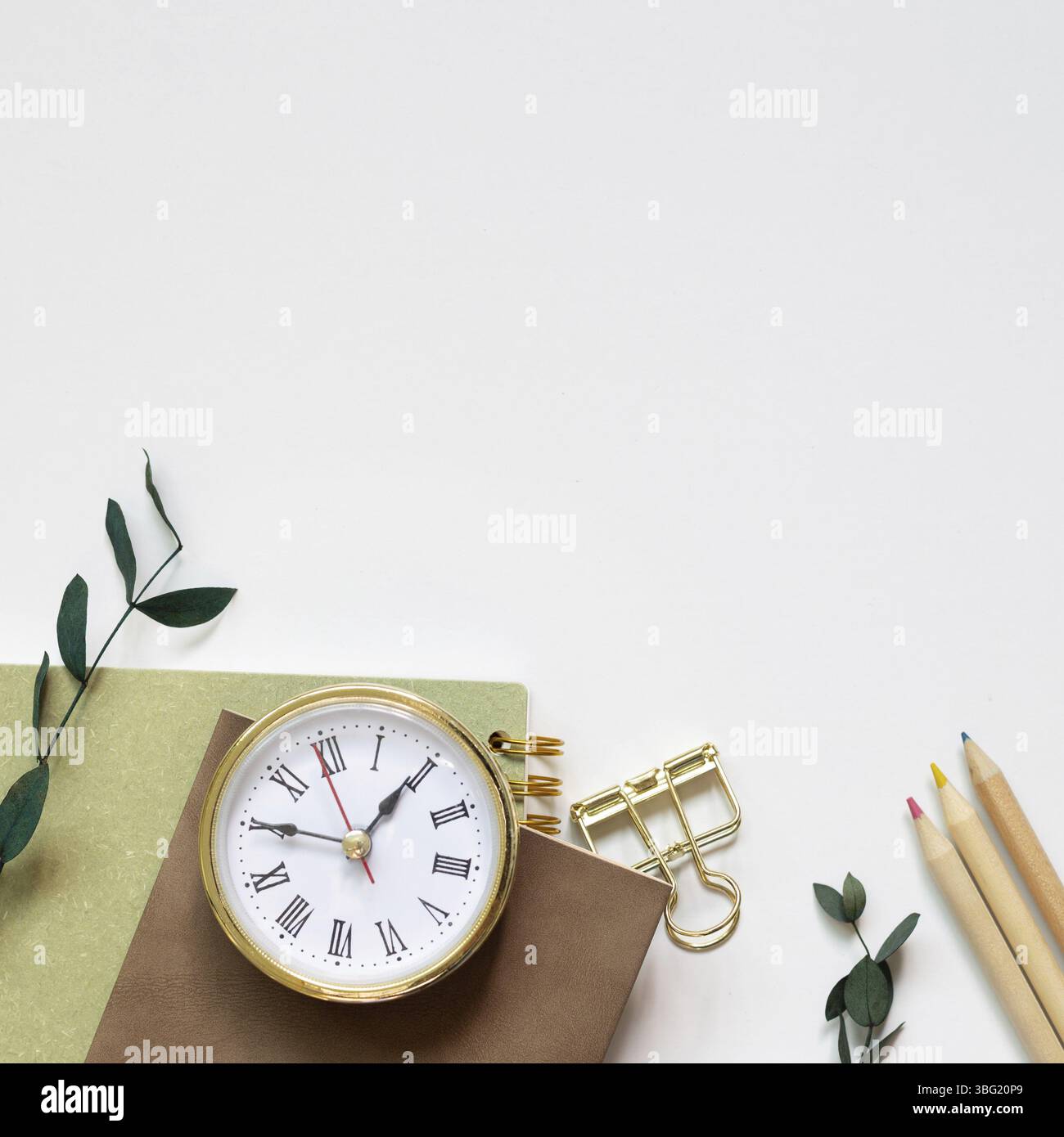 Notebook, pencil, clip, clock on white background. flat lay, top view, copy space Stock Photo