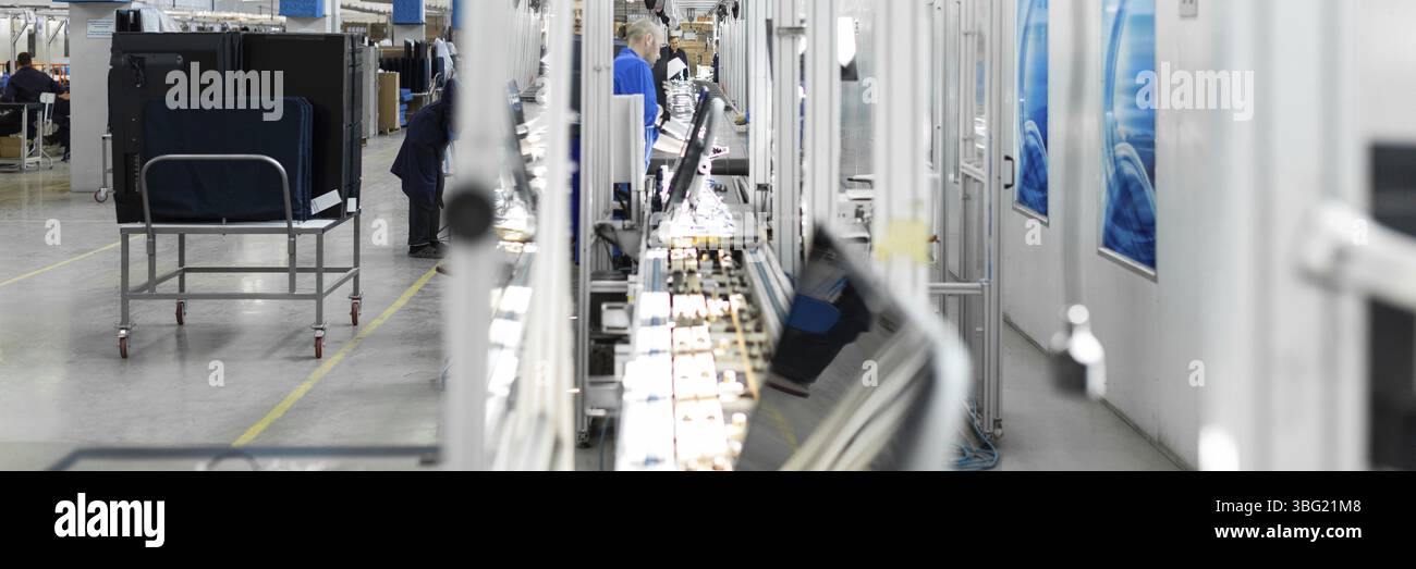 Workshop on assembling telephysics. Testing TVs in the workshop. Electronics assembly line Stock Photo
