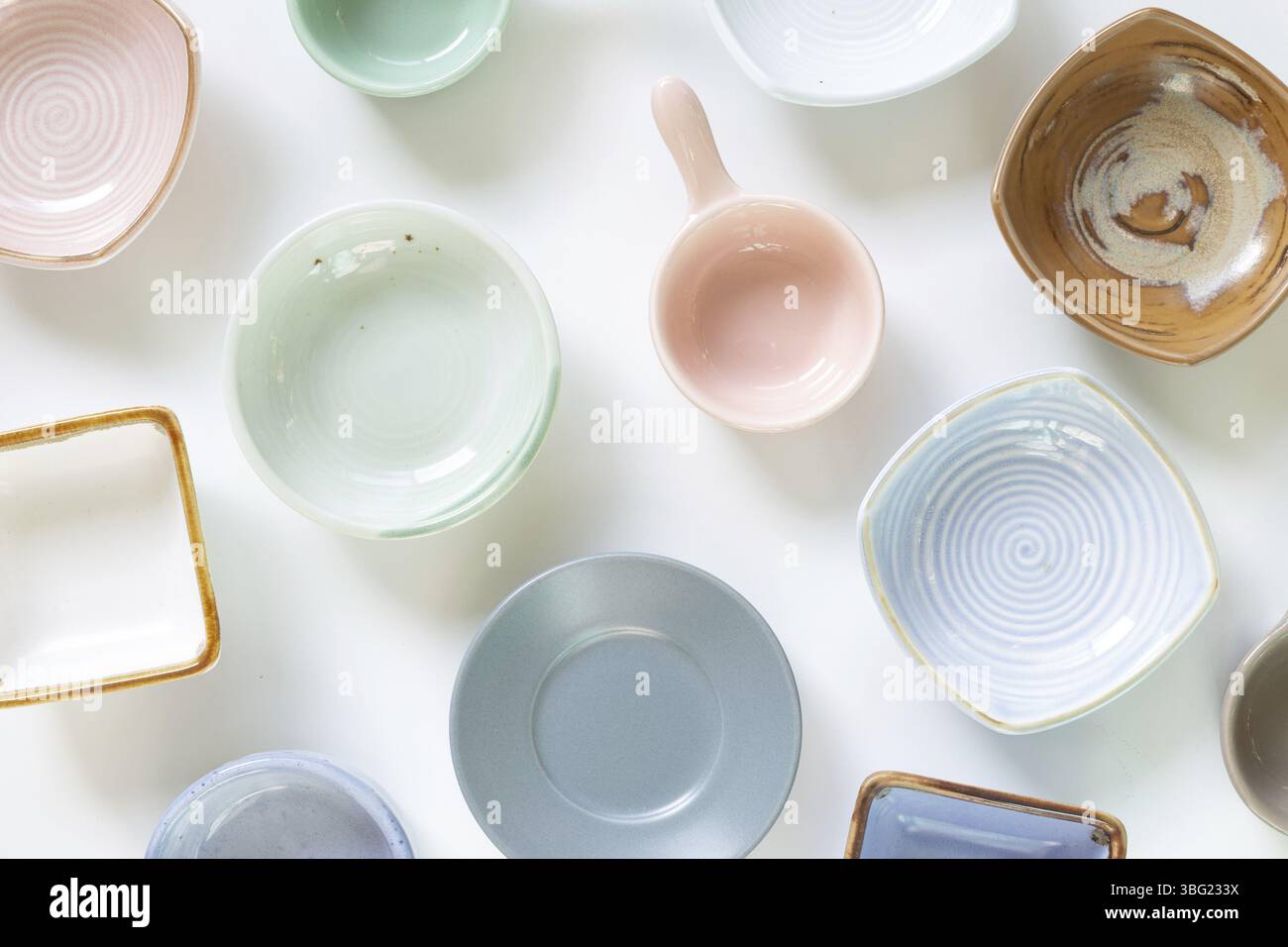 Colorful empty plates on white background. flat lay, top view Stock Photo