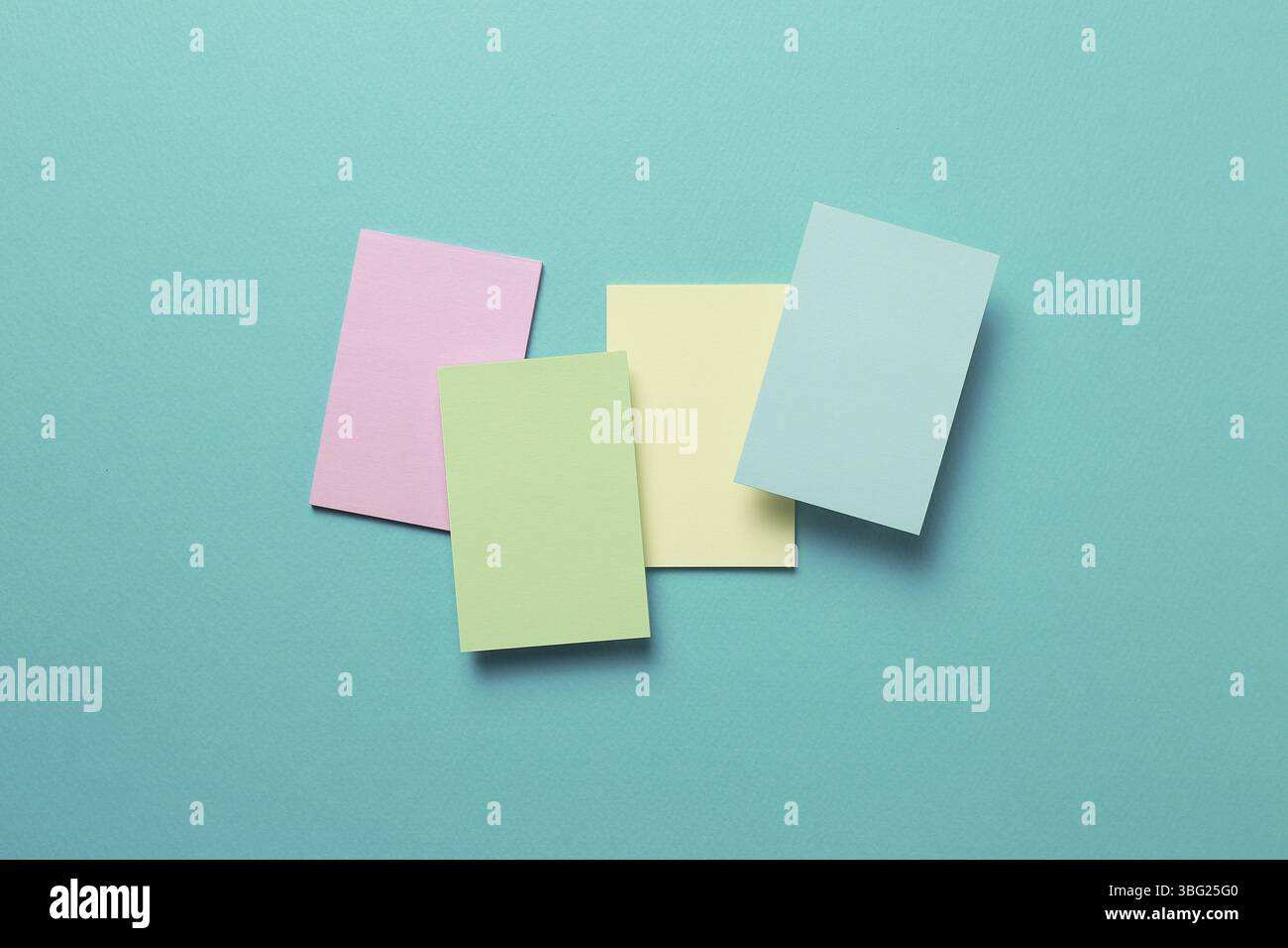 Colorful memo pad, sticky notes on mint background Stock Photo