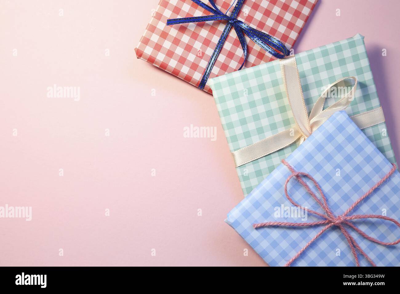 Check pattern colorful gift boxes on pink background Stock Photo