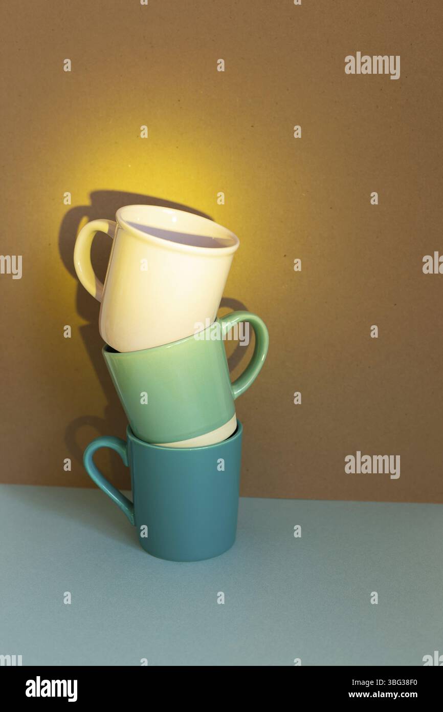 Three cups on blue table. brown wall background Stock Photo