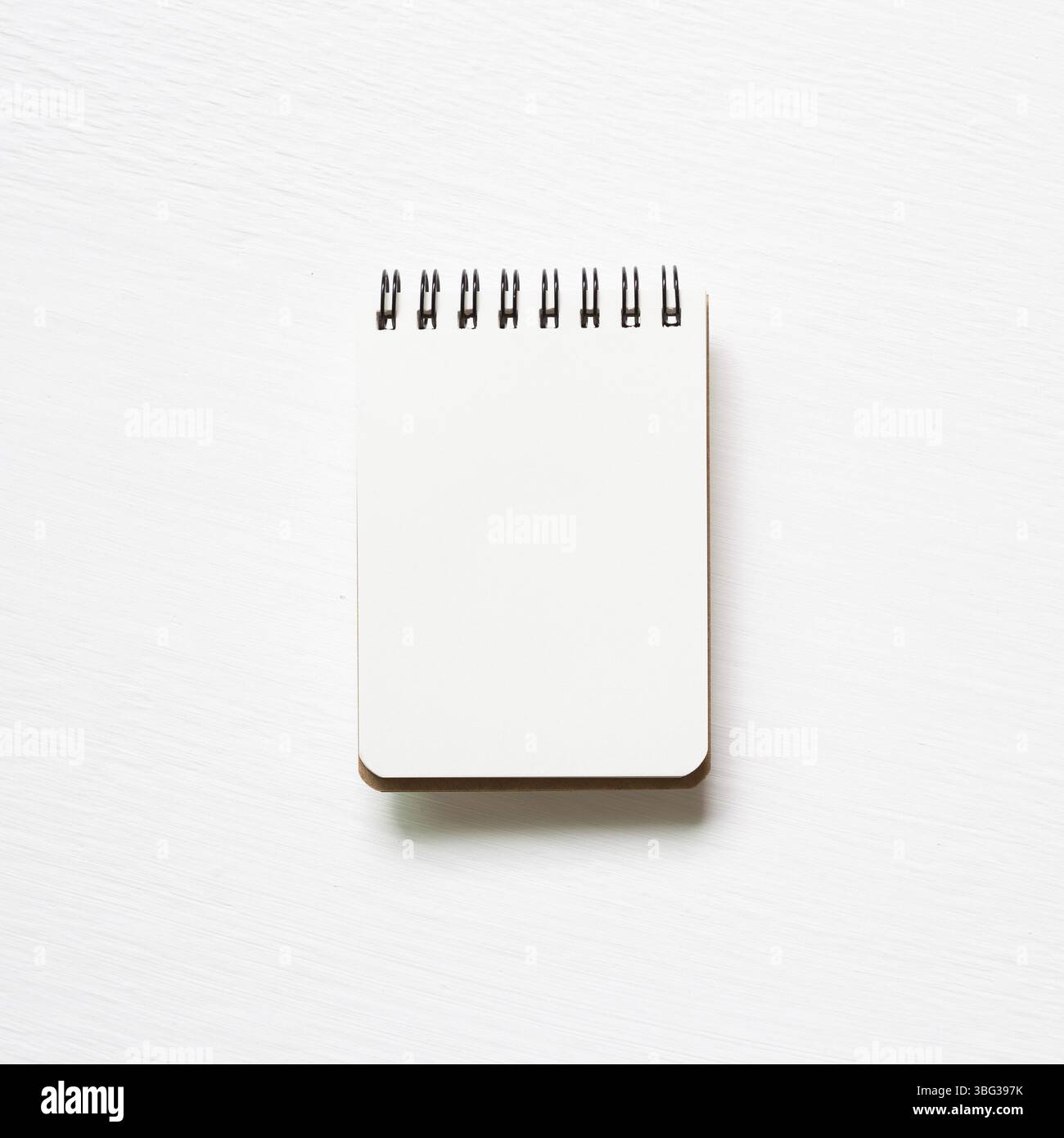 Empty spiral notebook on white painted background. top view, copy space Stock Photo