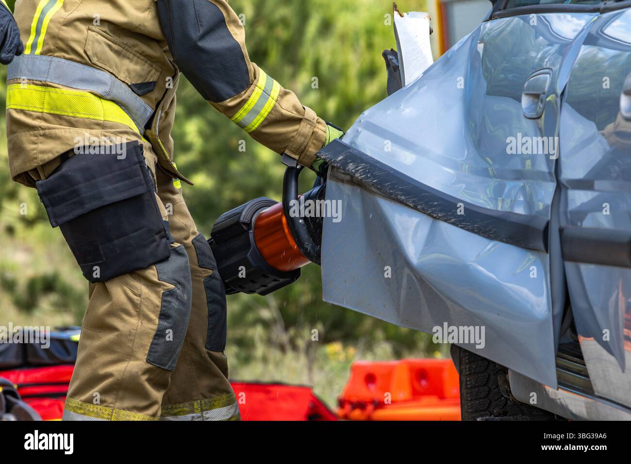 Firefighters pull a man trapped in a car after a car accident, rescue ...
