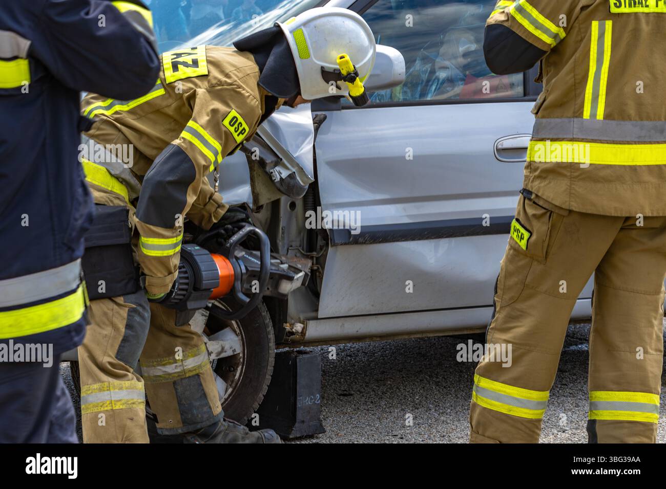 Firefighters pull a man trapped in a car after a car accident, rescue ...