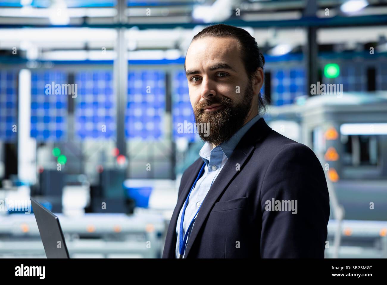 Factory inspector in a suit monitoring solar panel production output ...