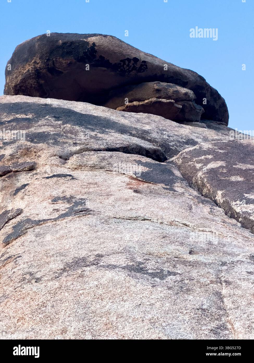 The view from the ground is truly magnificent, with impressive boulders perfectly balanced above. - Smartphone Captured Stock Image
