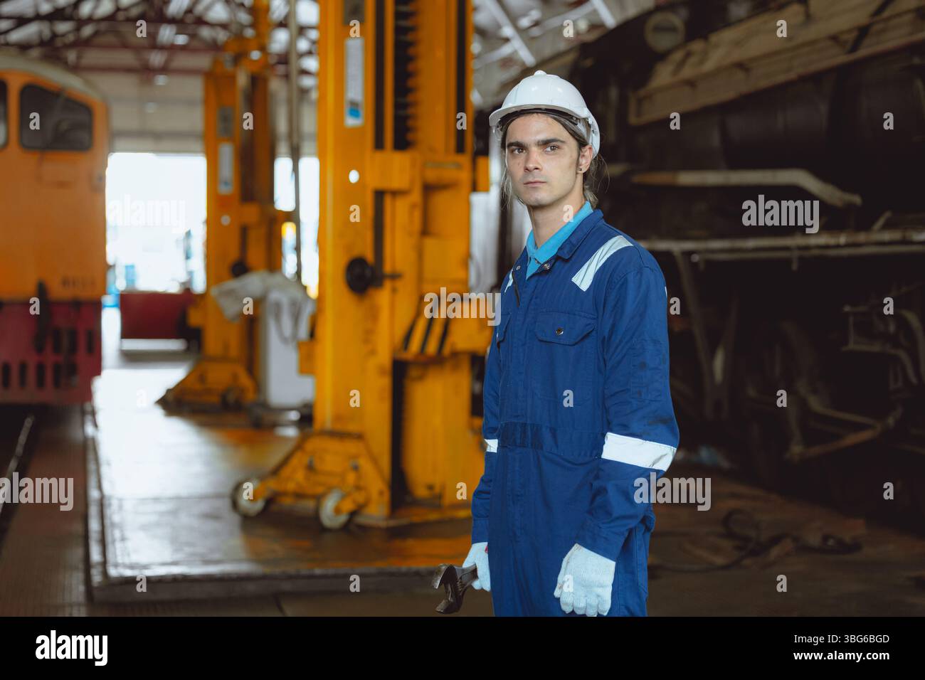 Portrait young man train engineer male, Confident worker standing proud ...