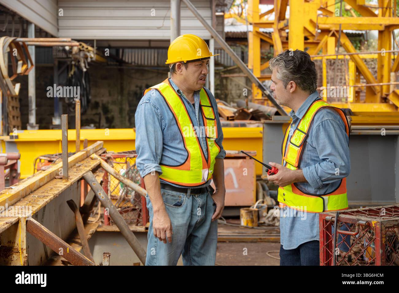 Construction engineer team working together join teamwork talking together at construction site Stock Photo