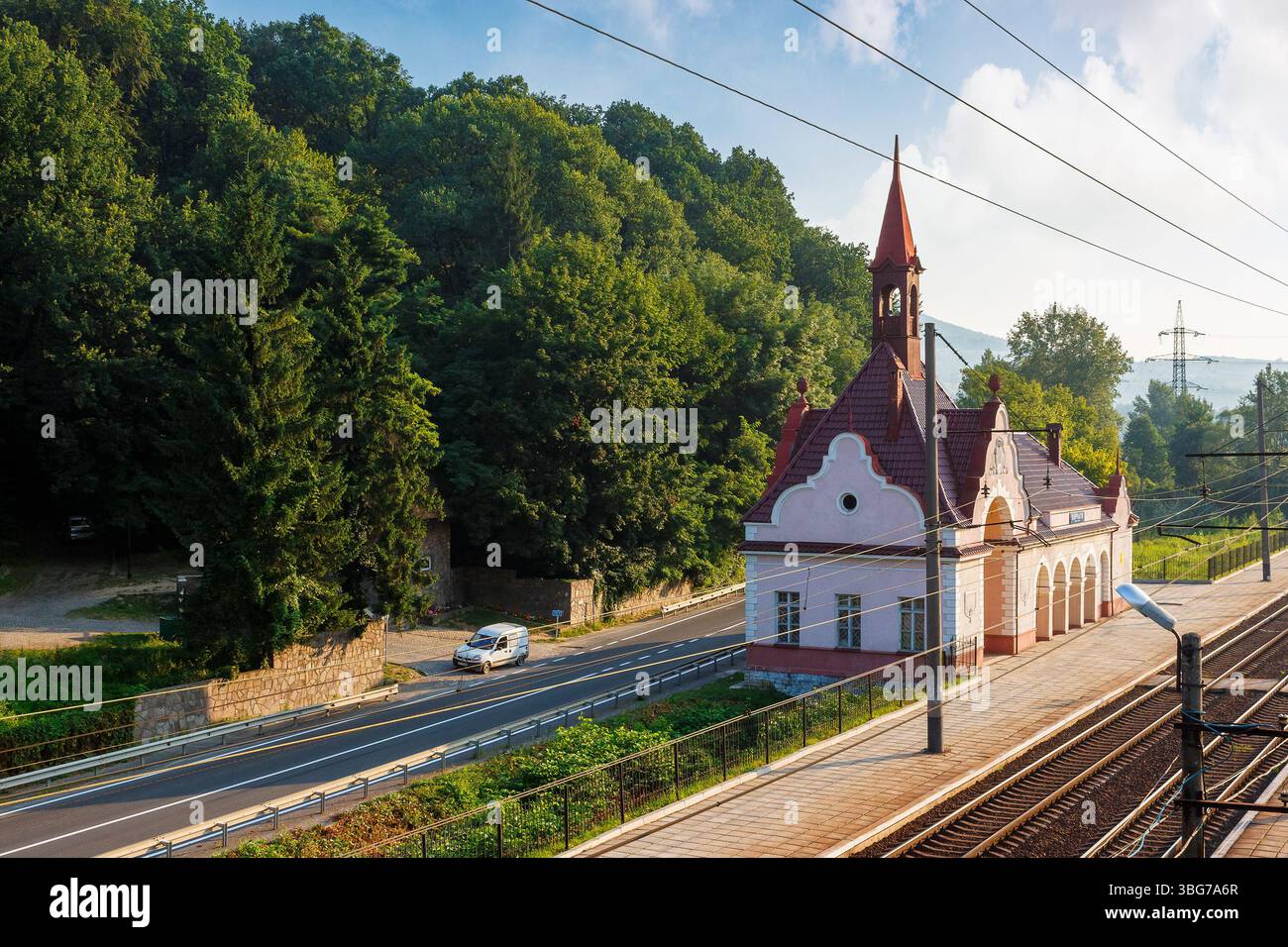 karpaty, zakarpattia/ukraine - jul 28, 2013: old railway station karpaty in morning light. historical building in carpathian mountains in summer. aust Stock Photo
