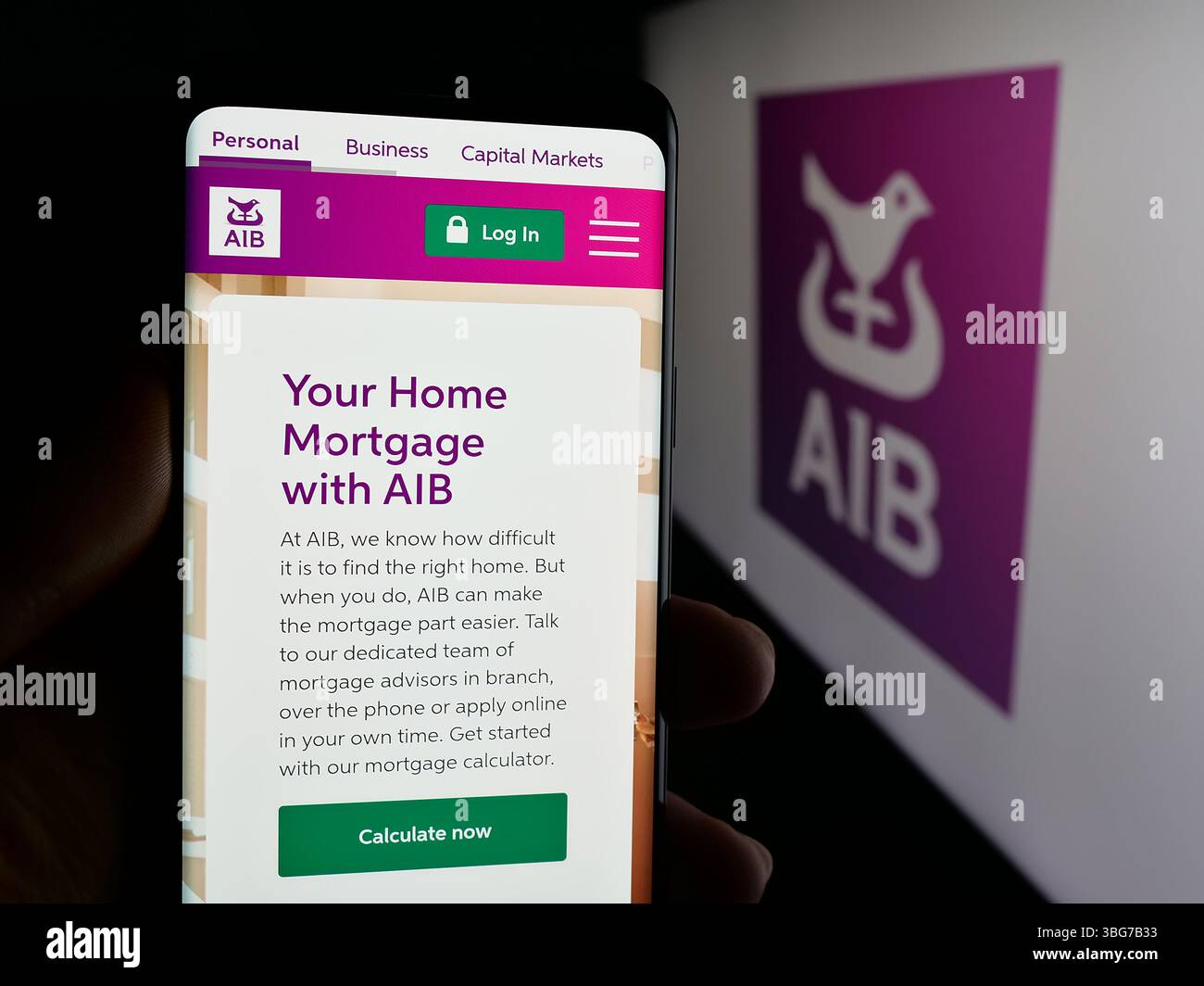 Stuttgart, Germany - 01-28-2025: Person holding smartphone with web page of financial company Allied Irish Banks plc (AIB) on screen with logo Stock Photo