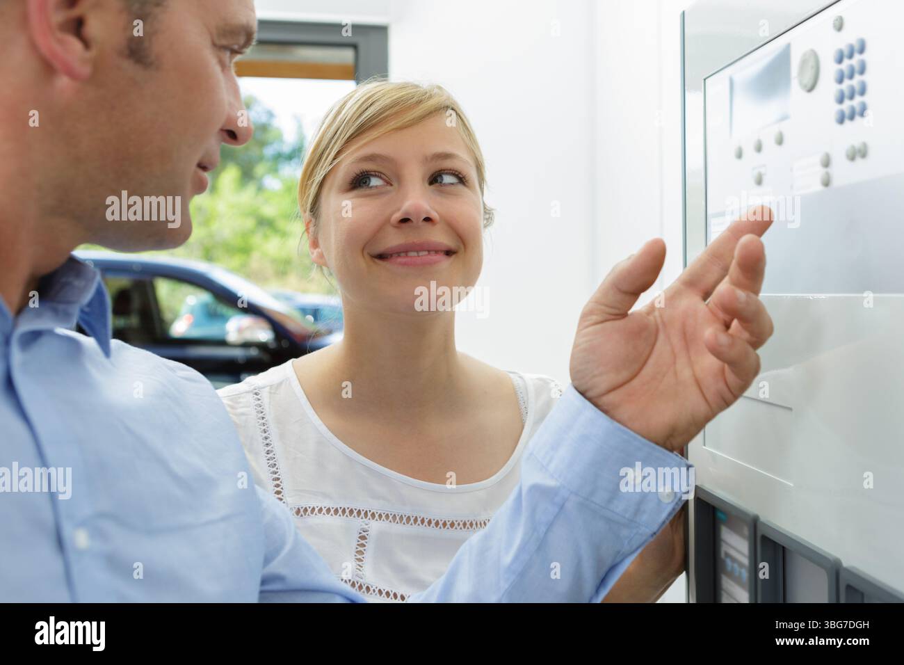 man and woman push down the electronic control machine Stock Photo