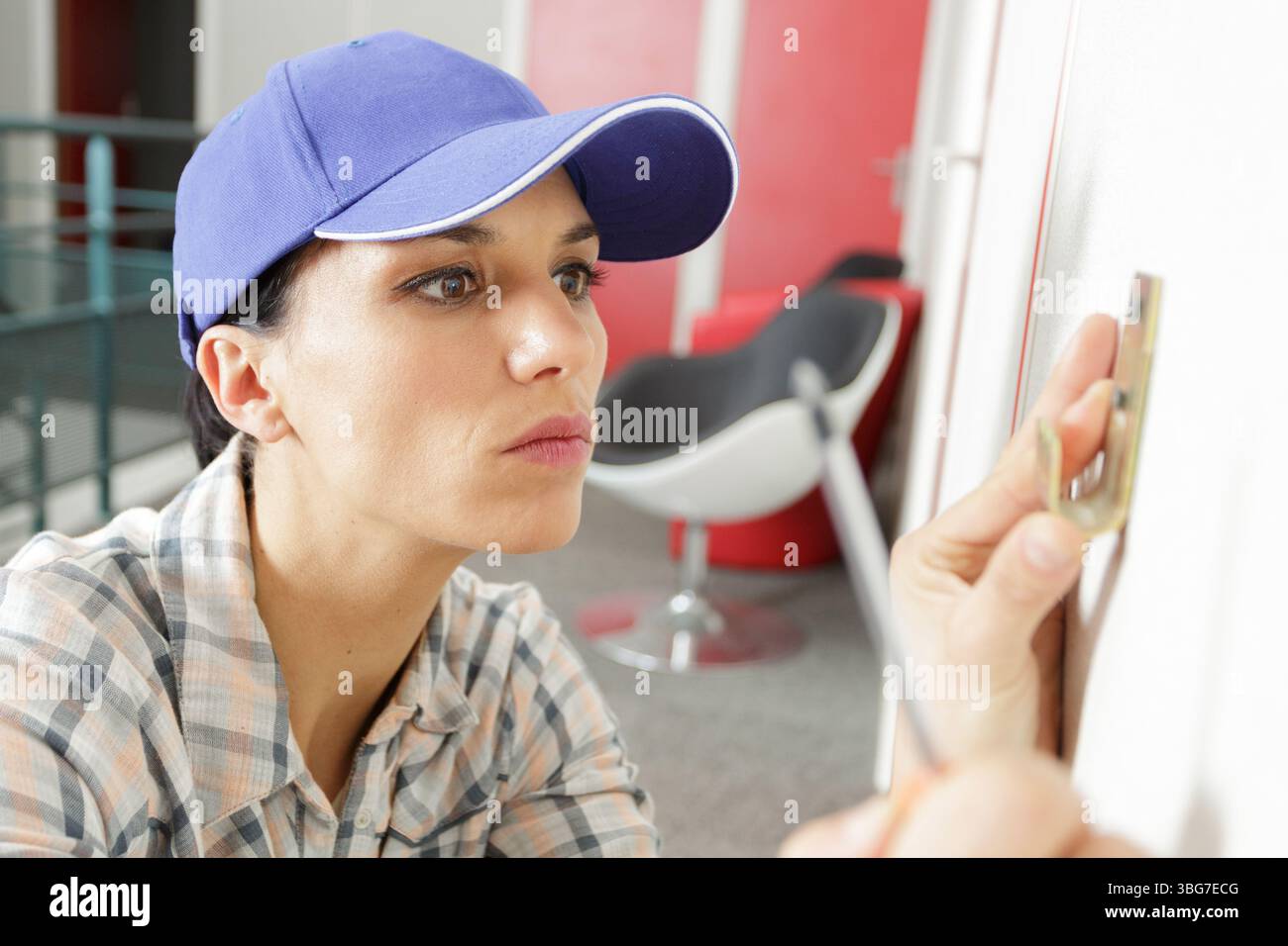 young woman using a screwdriver Stock Photo