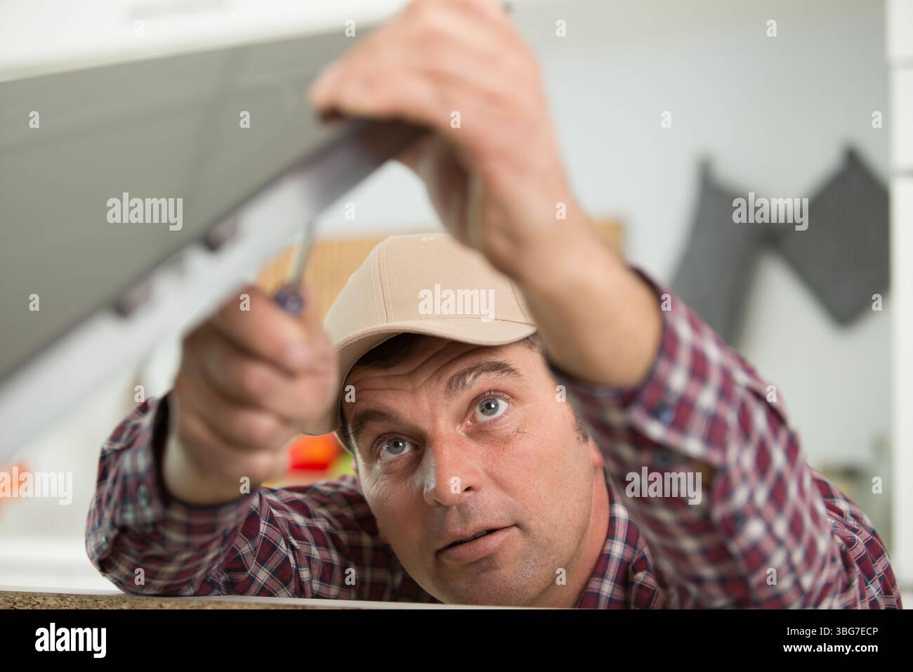 builder sets fittings on the window Stock Photo
