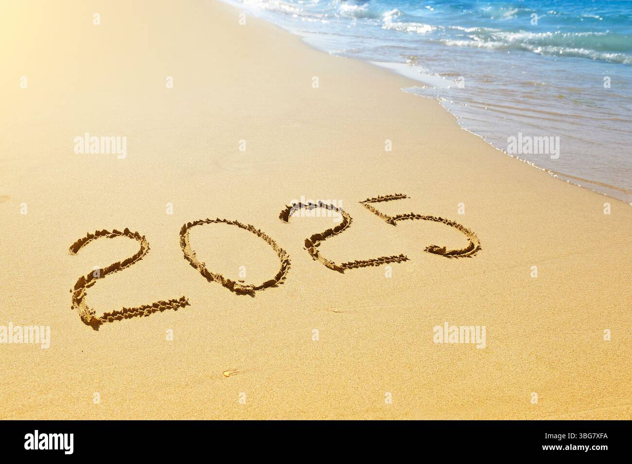 New year 2025 written on sand Stock Photo