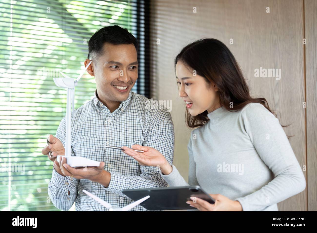 Collaborative Discussion. Team members brainstorming on renewable energy solutions. Stock Photo