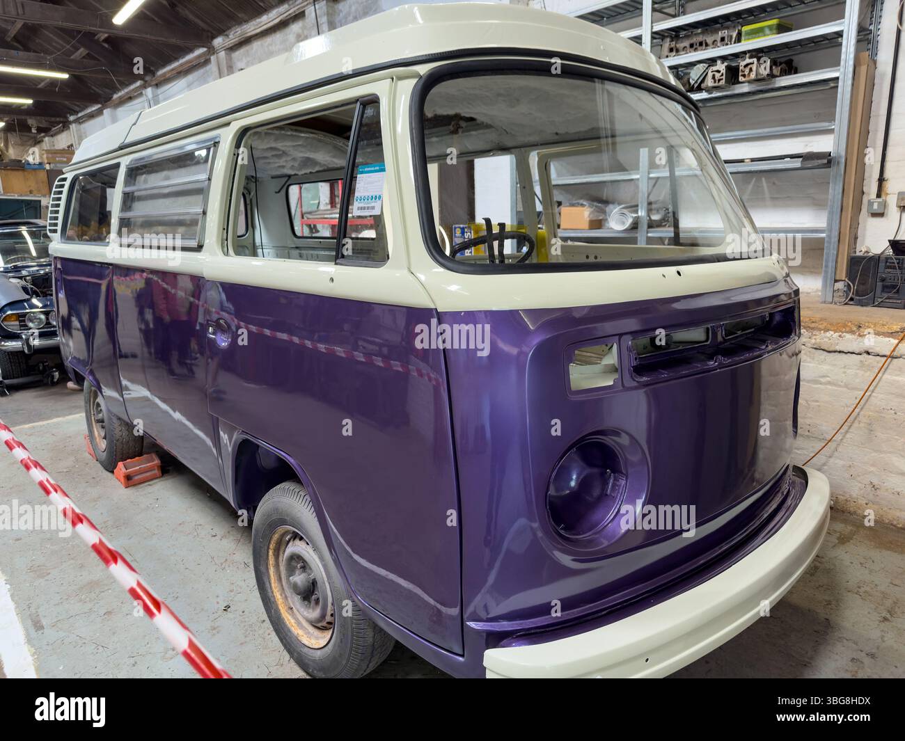 vintage purple VW Volkswagen bay window campervan undergoing restoration in workshop - Smartphone Captured Stock Image