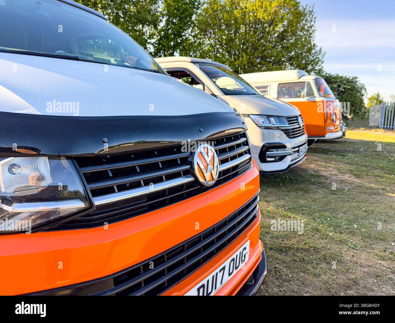 row of 3 classic volkswagen transporter campers or campervans of different generations or types - Smartphone Captured Stock Image