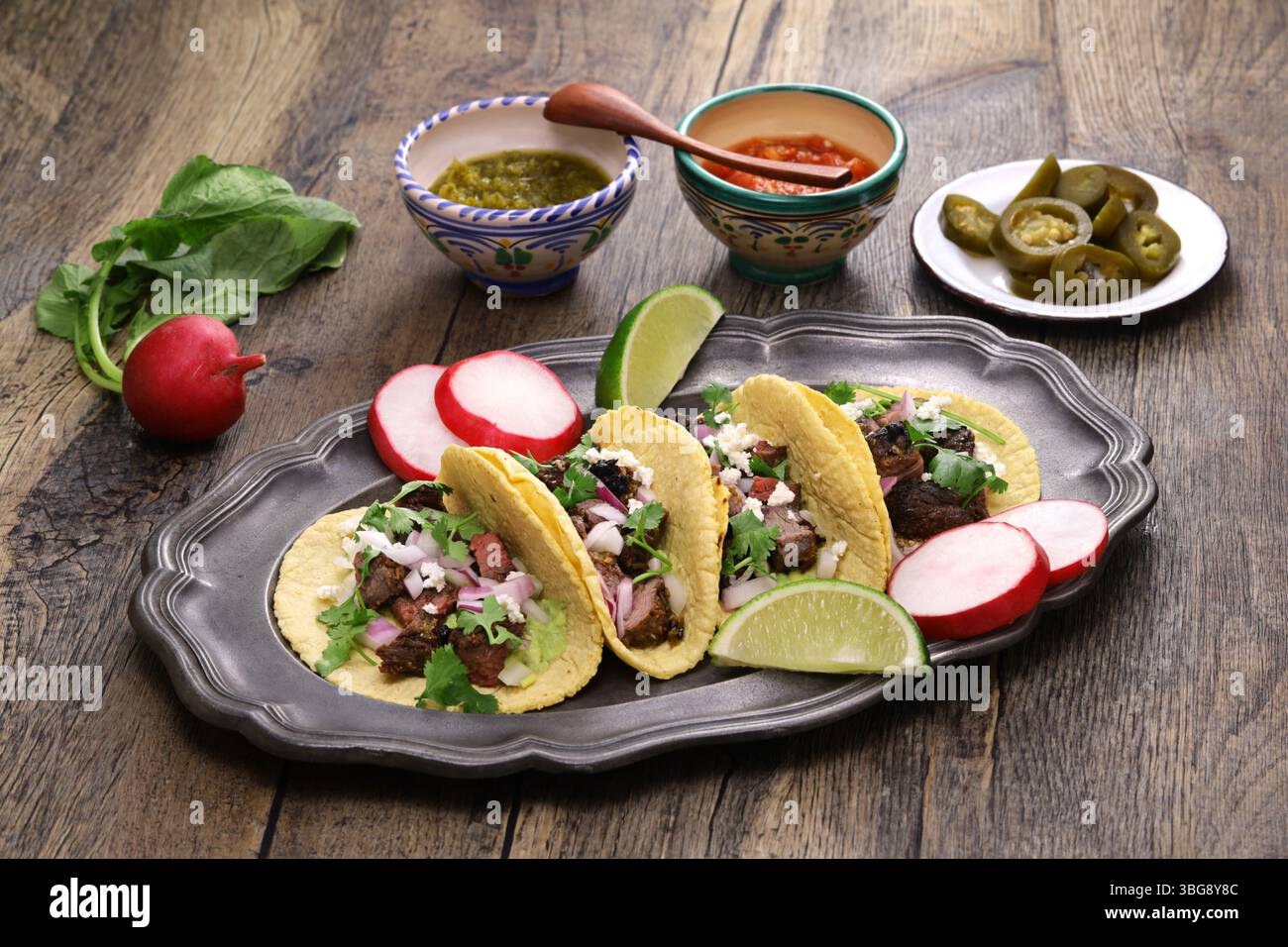Carne asada tacos with salsa verde and roja, Mexican food Stock Photo