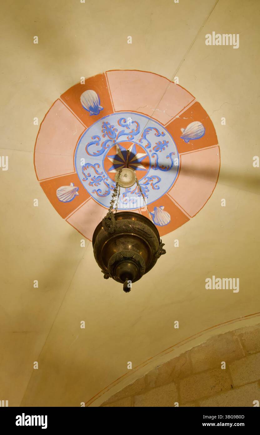 Metal ceiling uplighter lighting with painted ceiling decoration Co-cathedral of Saint Mary Caceres Extremadura Spain Stock Photo