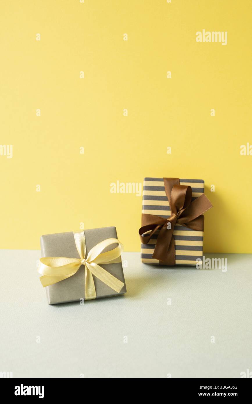 Gift boxes on gray table. yellow wall background Stock Photo