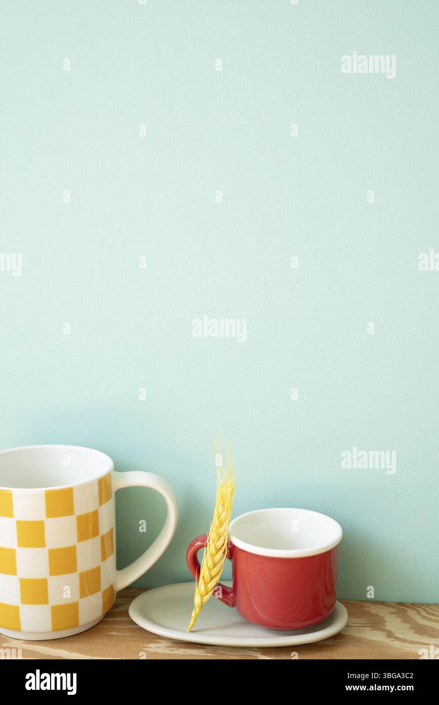 Empty mug cups on wooden shelf. mint wall background Stock Photo