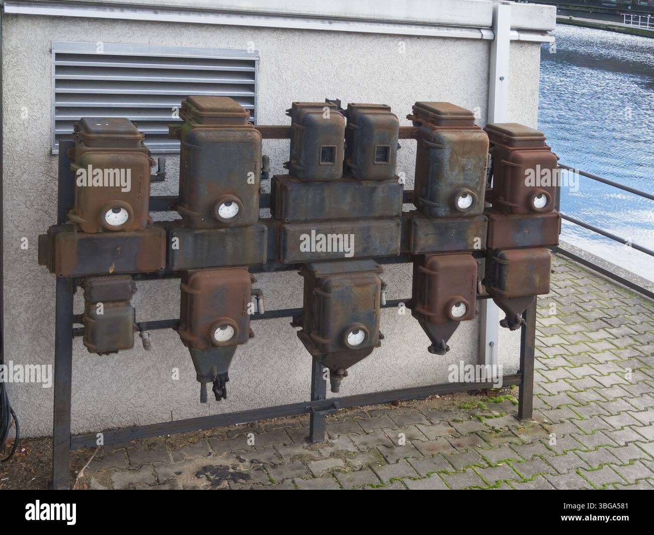 Old electrical connection boxes on a white wall Stock Photo