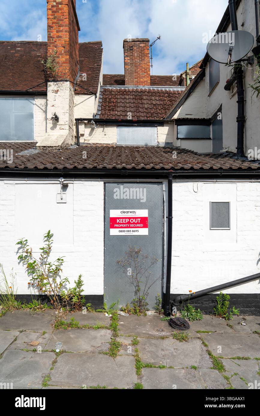 Secured Building Sign Entrance door to empty building secured by sheet metal plate with keep ...