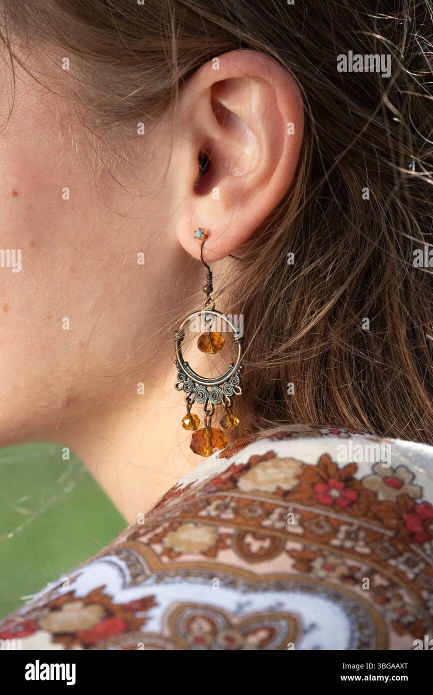 Female head with earring hi-res stock photography and images - Alamy
