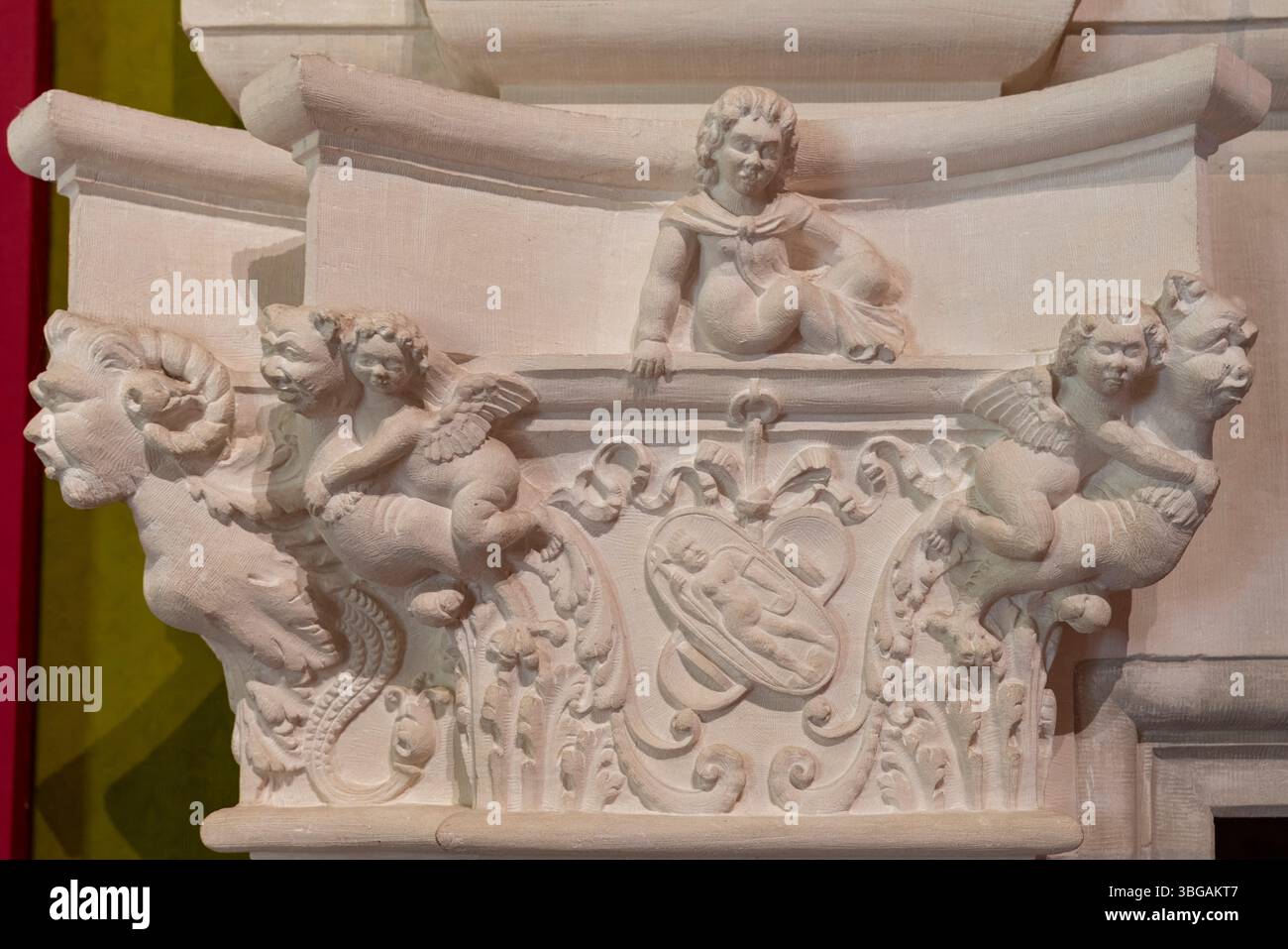 Ornate stone relief displays cherubs and mythical creatures in ...