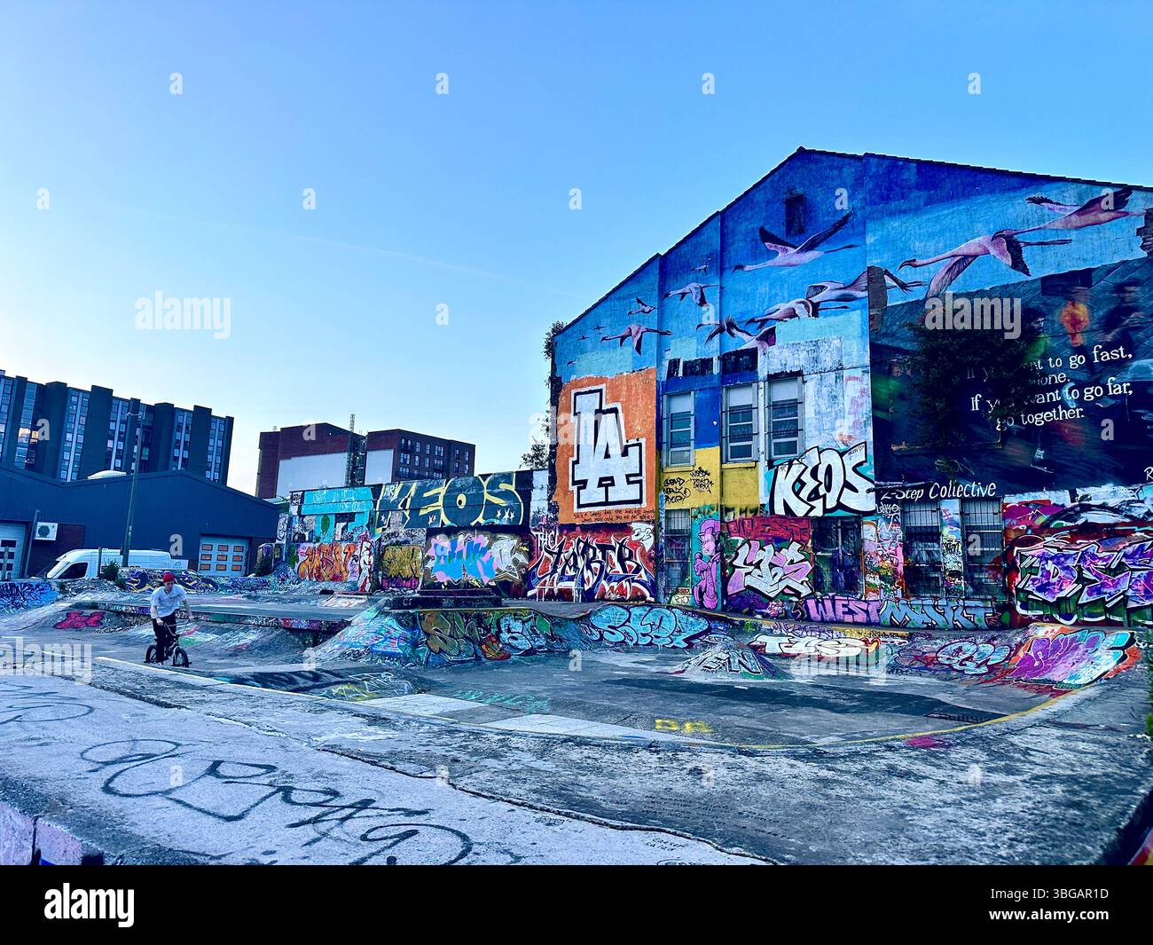 BMX rider at colourful graffiti-covered skate park in the Baltic Triangle, Liverpool, 2 June 2025 - Smartphone Captured Stock Image