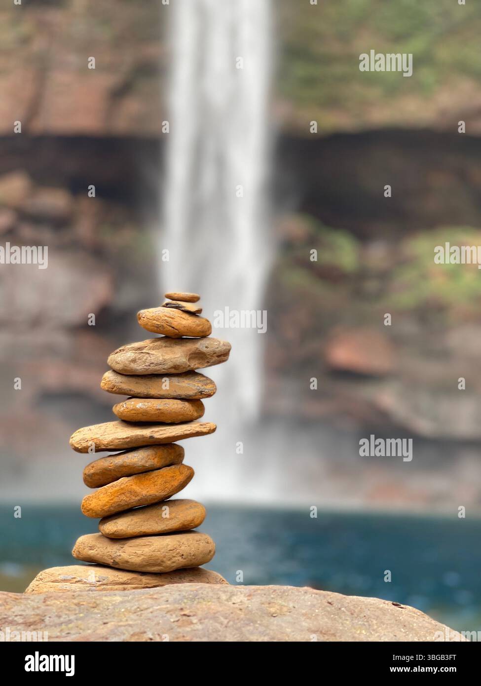 Natural Harmony – Rock stack symbolizing balance and peace near Phe Phe Waterfalls, Meghalaya, Northeast India. Balanced rock stack.Discover Meghalaya - Smartphone Captured Stock Image
