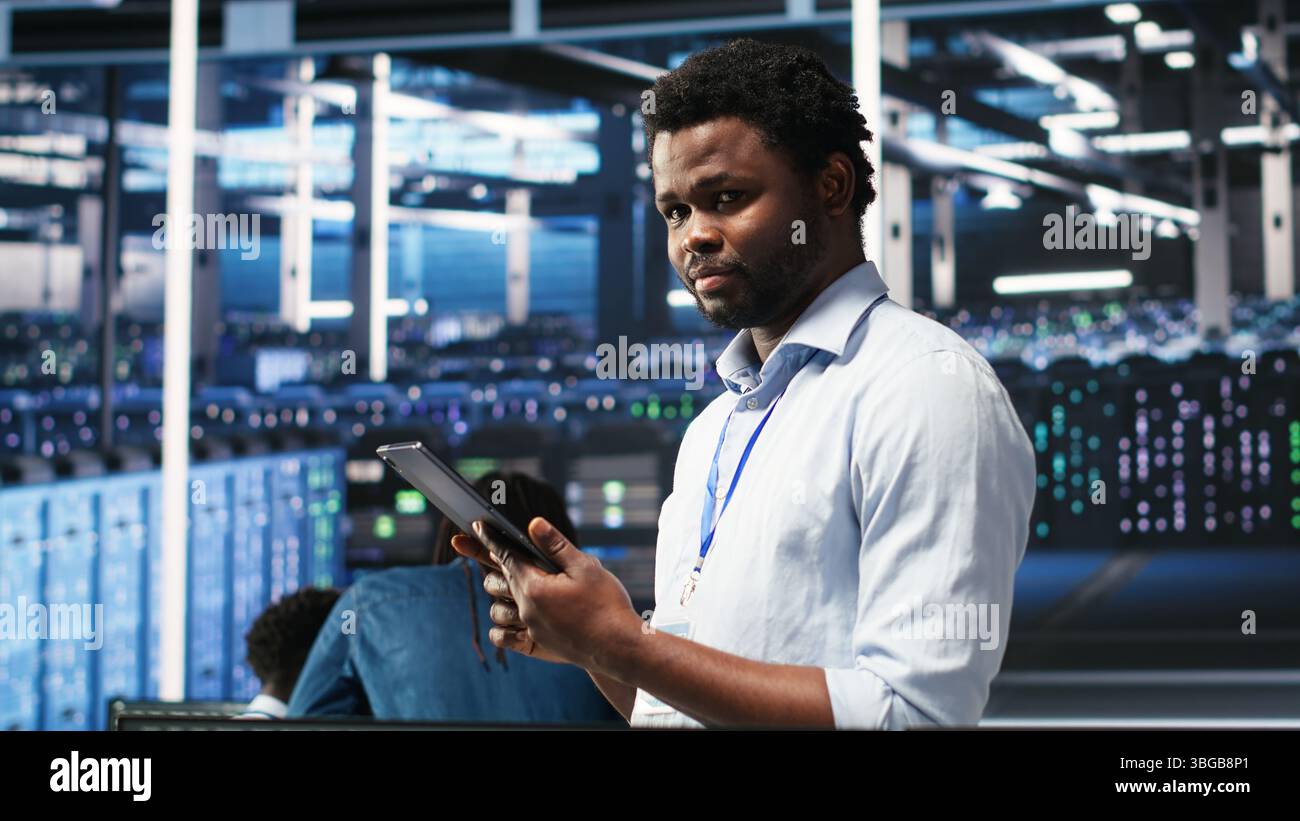 Data center technician uses node tree programming interface to identify equipment performance issues. Engineer reviews data analysis graph in server hub to minimize hardware failures, camera B Stock Photo
