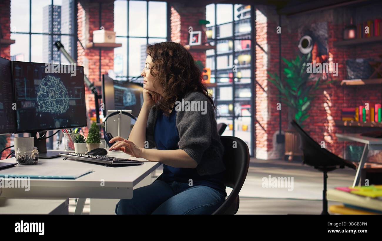 Teleworking developer using computer for artificial intelligence brain computing through self learning algorithms. Agency IT engineer works with AI deep neural networks on desktop PC. Camera A. Stock Photo