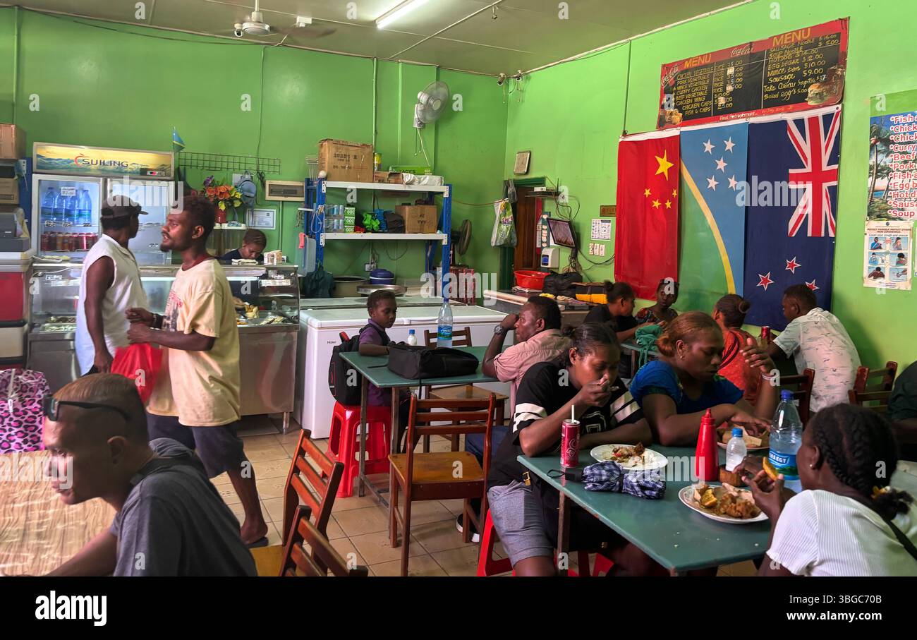 Crowded restaurant with Chinese, SI and NZ flags, Honiara, Guadalcanal, Solomon Islands. No PR or MR - Smartphone Captured Stock Image