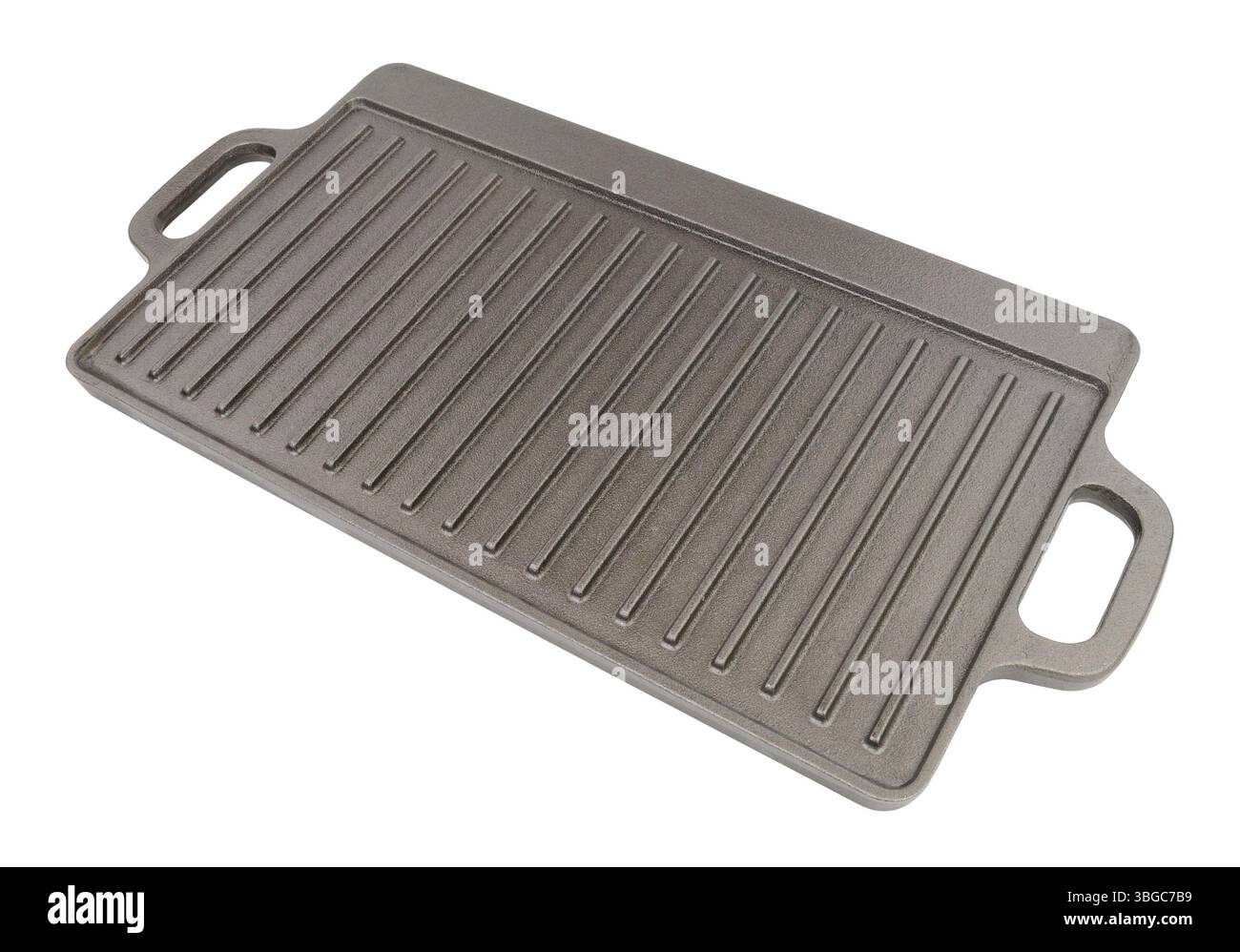 Cast iron metal griddle pan with handles incorporated isolated on a white background Stock Photo