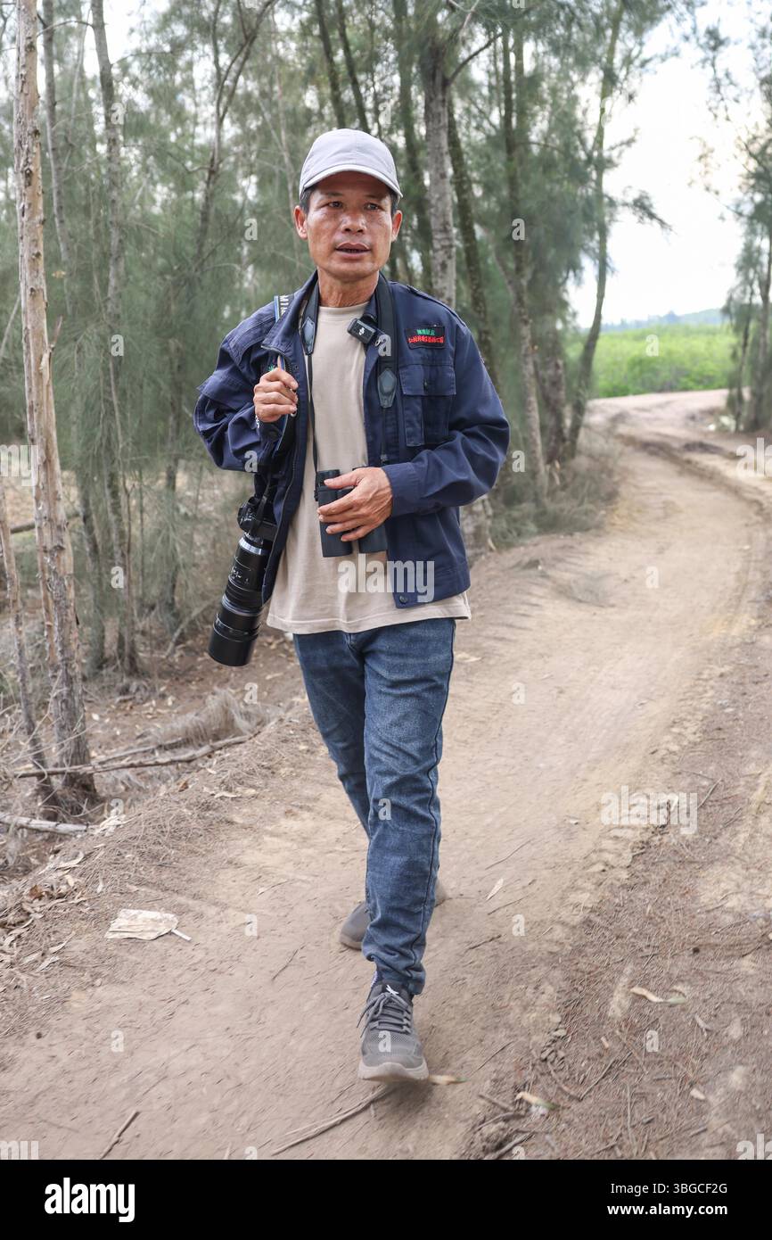 (250605) -- HAIKOU, June 5, 2025 (Xinhua) -- Luo Lixiang patrols at the ...