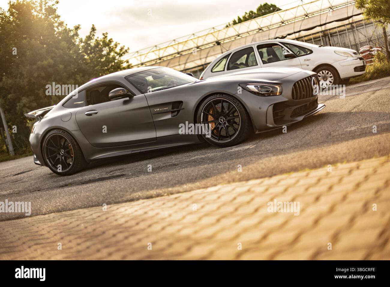 Milan, italy 4 june 2025, grey mercedes amg gtr parked elegantly beside ...