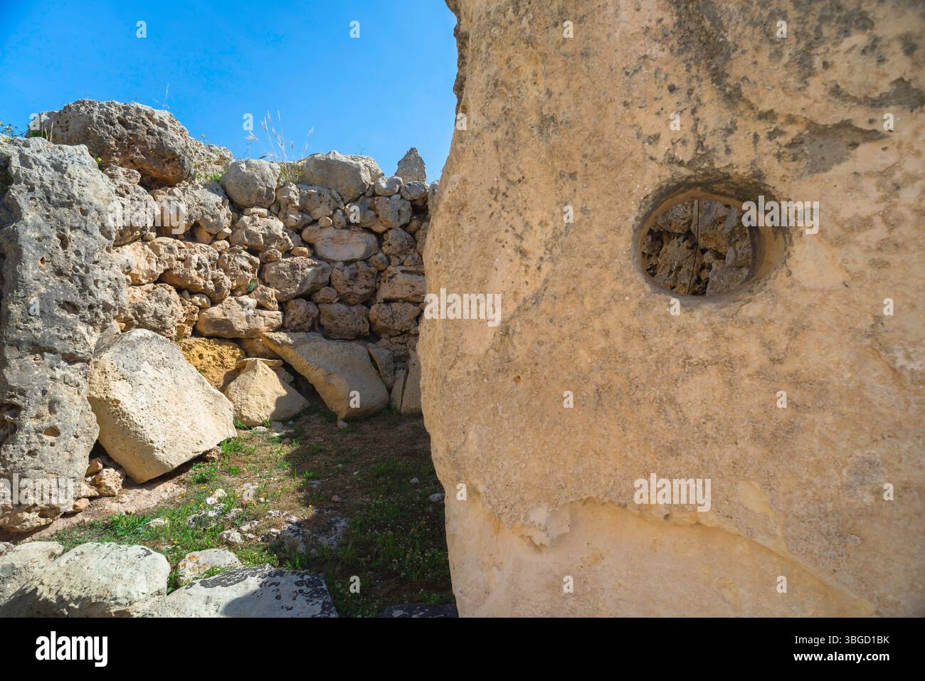 Megalithic temple Malta, view of a huge upright stone showing a circular aperture believed to function as a timber support slot, Ggjantija, Gozo Malta Stock Photo
