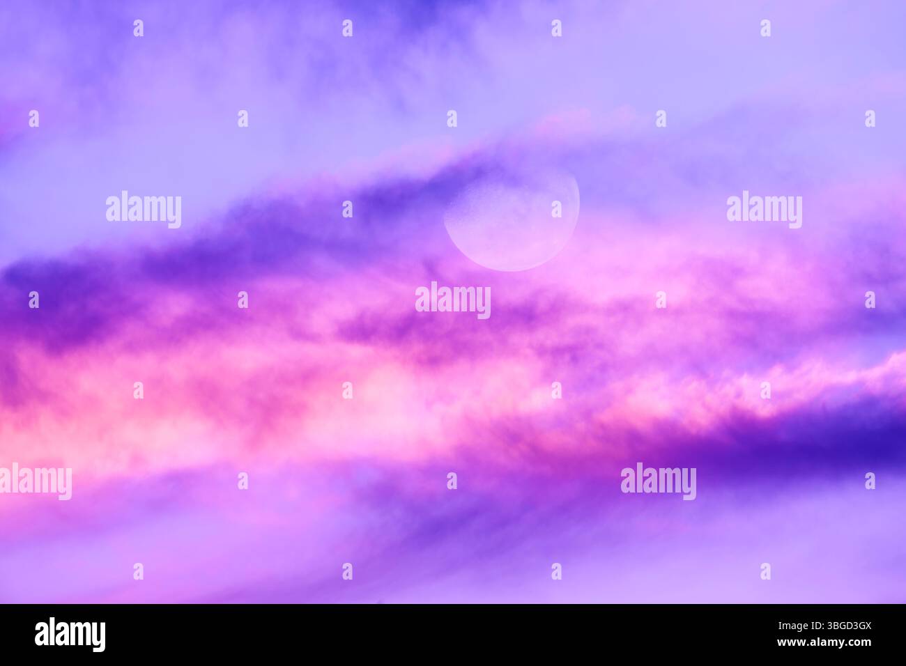 A Full Moon Against A Detailed Colorful Cloudscape Stock Photo