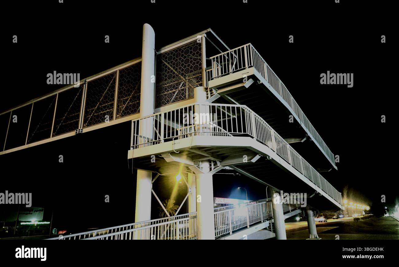 Road crossing bridge illuminated at night in Sohar, Al Batinah North Governorate, Oman, serving daily commuters. Photographed on June 4, 2025 - Smartphone Captured Stock Image