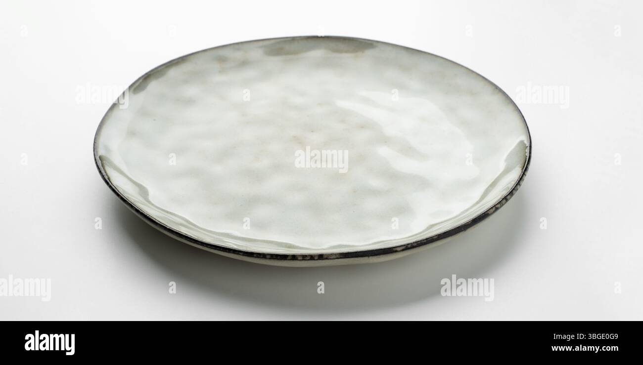 Empty gray textured plate on white background Stock Photo